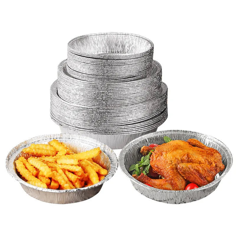 Round disposable aluminium foil liners for air fryers in four different sizes on a kitchen counter.
