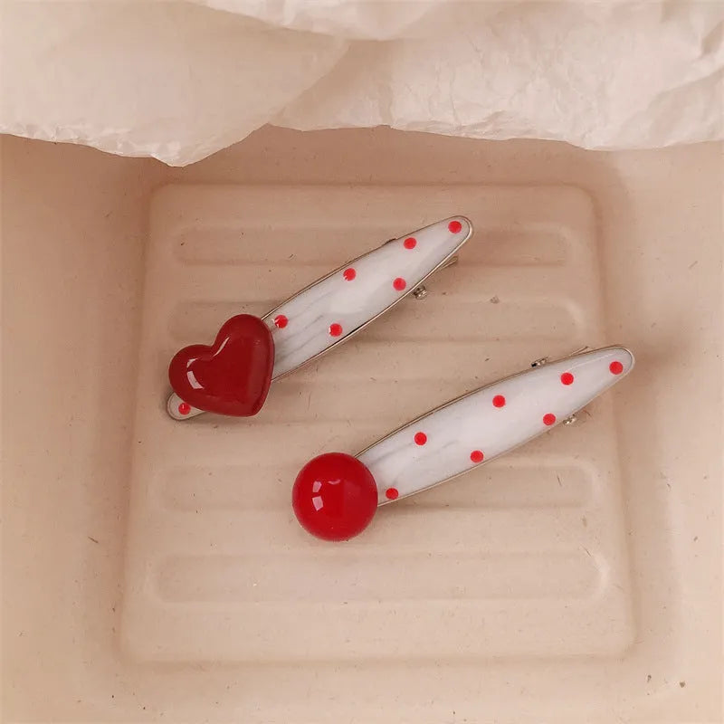 Red love heart-shaped hair barrette clip with retro white dots on a willow leaf-shaped base.