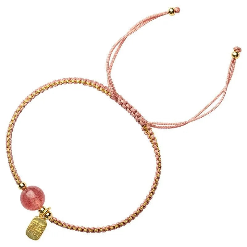 Adjustable red rope bracelet with transfer beads in Strawberry Quartz style on a wrist.
