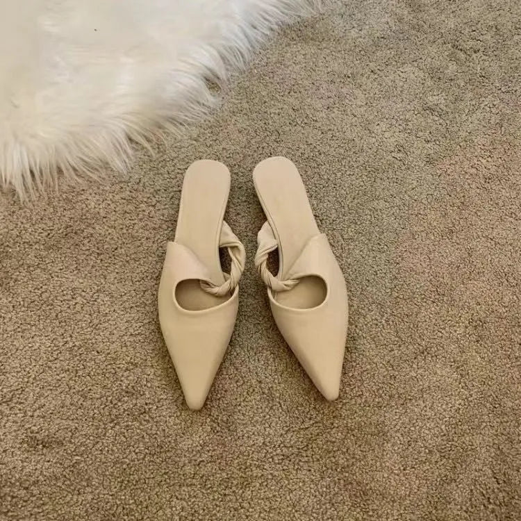 Women's soft leather-lined semi-toe box slippers in neutral colours on a rubber sole.