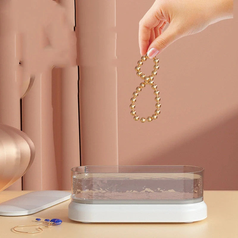 Compact ultrasonic cleaning machine for watches and small items, white colour, on a table