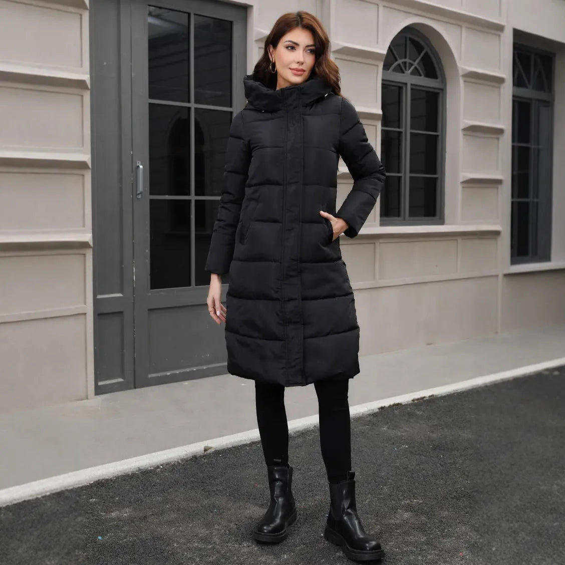Black hooded slim fit polyester jacket with long sleeves on a model showing cold-resistant construction
