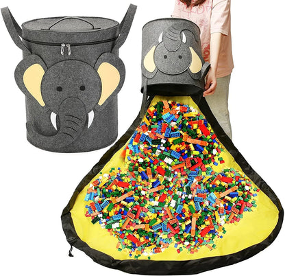 Green felt storage cube with pull rope, unfolded flat as a square play mat next to toys.