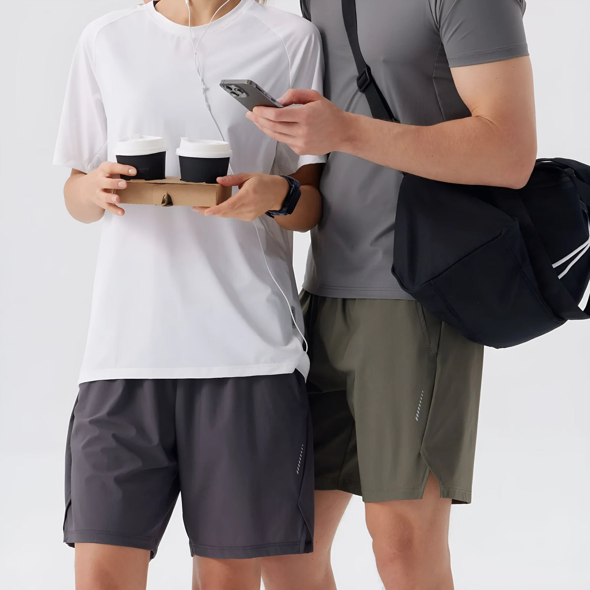 Men's black nylon sports shorts with mid-waist, shown flat.