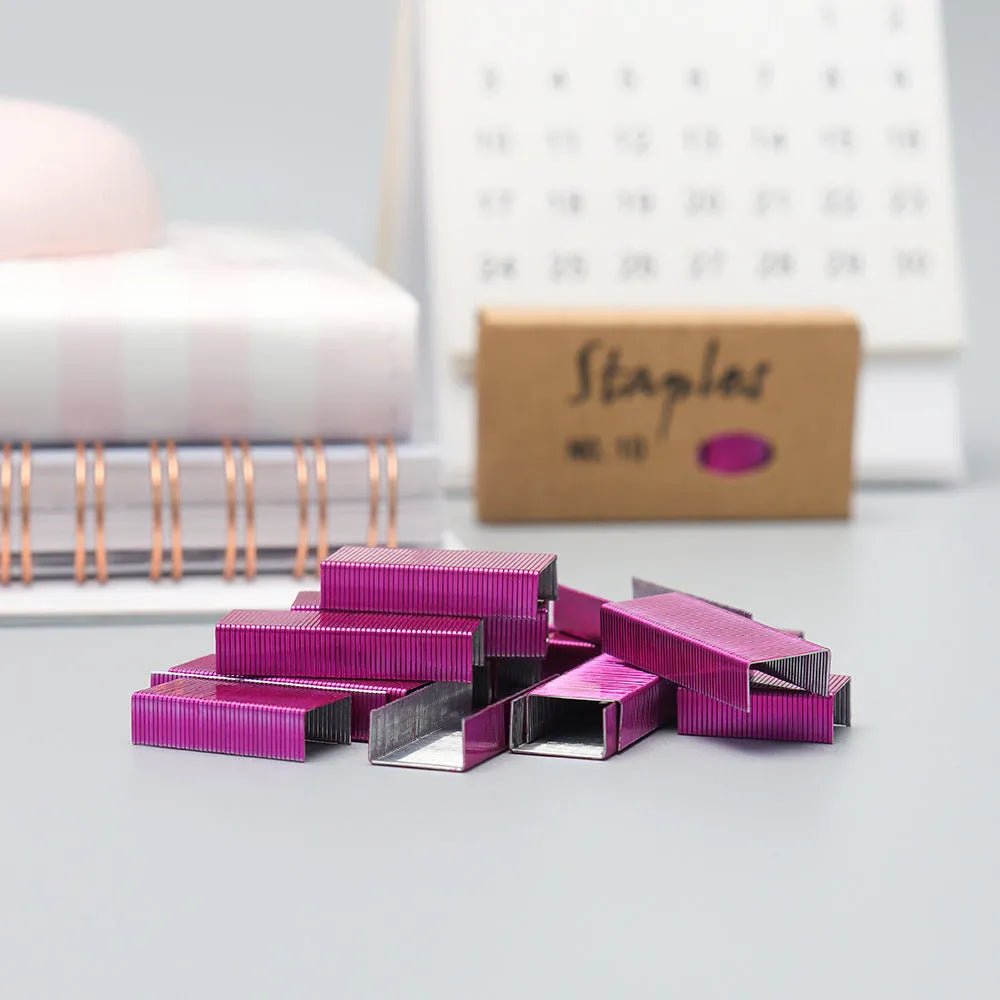 Box of 1000 metal stapling needles in rose gold, black, purple, and rose red colours.