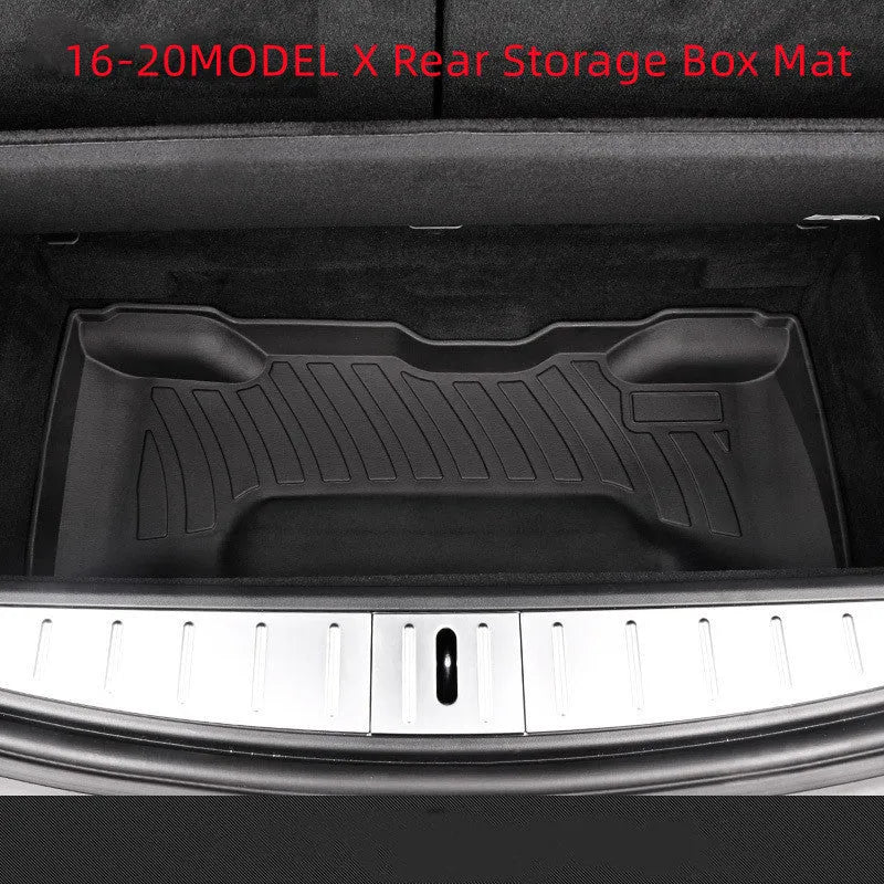 Custom black rubber floor mats fitted in a Tesla Model 3, showing textured surface and TPE driver footrest.