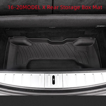 Custom black rubber floor mats fitted in a Tesla Model 3, showing deep grooves and raised edges.