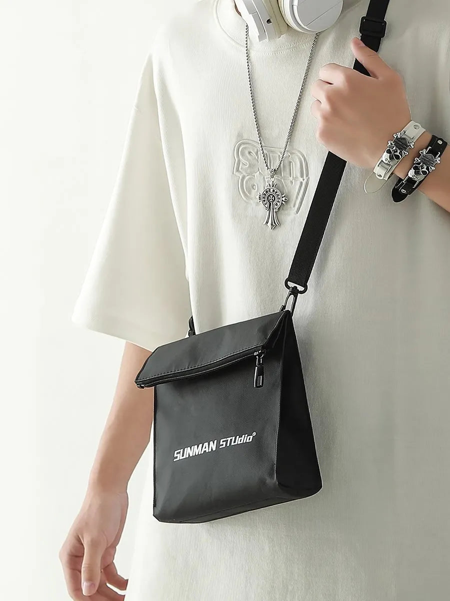 Polyester Oxford fabric messenger-style backpack in khaki colour with visible stitching and a crossbody strap.