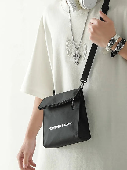 Polyester Oxford fabric messenger-style backpack in khaki colour with visible stitching and a crossbody strap.