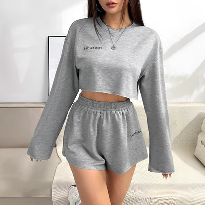 Grey women's long-sleeved T-shirt and shorts polyester lounge set laid flat.
