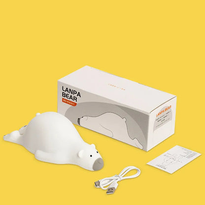 White bear-shaped silicone night light on a table with USB cable.