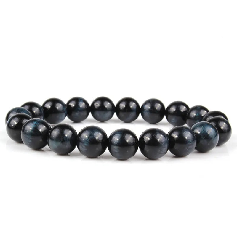 Natural tiger eye crystal bead bracelet showing round geometric beads on a wrist, available in multiple sizes and colour variations.
