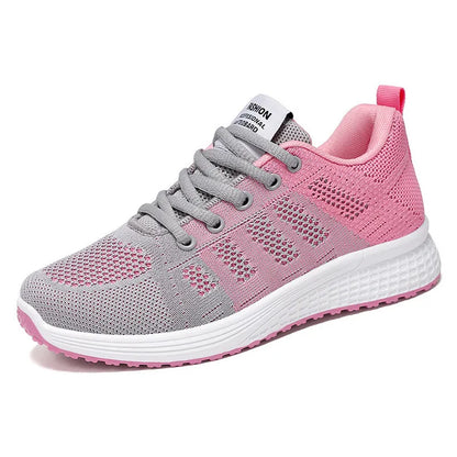 Women's flyknit running shoes in grey pink with soft sole and lace-up front.