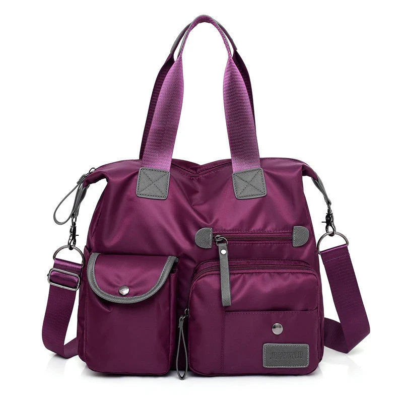A fashionable and versatile ladies tote bag with multiple compartments and carrying options for the modern woman on the move.