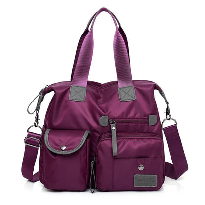 A fashionable and versatile ladies tote bag with multiple compartments and carrying options for the modern woman on the move.