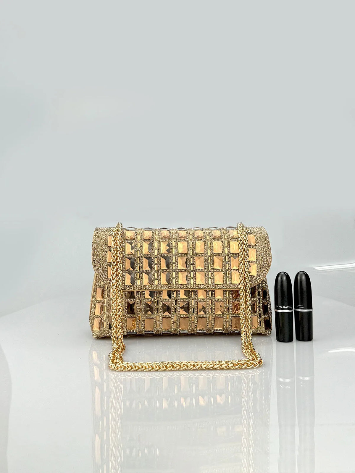 Silver rhinestone-decorated PU leather clutch bag with a metal chain strap, shown open to reveal interior phone pocket.