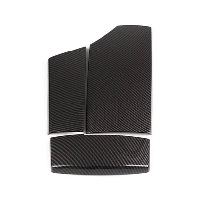 Set of three black ABS armrest box covers with a diagonal carbon fibre weave pattern and polished surface.
