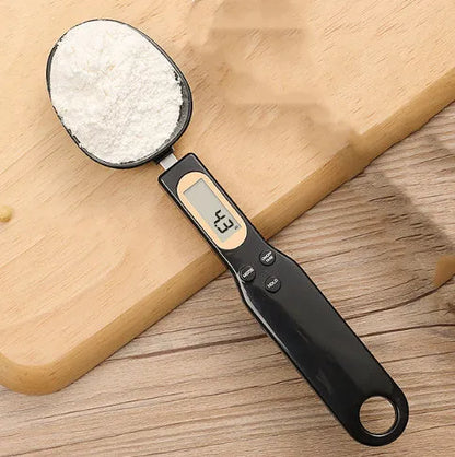 White digital spoon kitchen scale with LCD display showing weight measurement