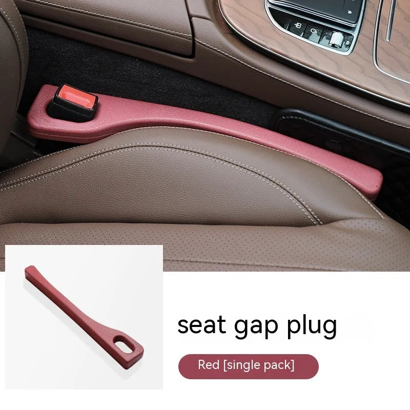 Polyurethane car seat gap filler strip in assorted colours on a car seat.
