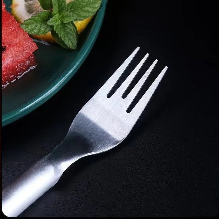Stainless steel watermelon slicer and serving fork on a kitchen counter.