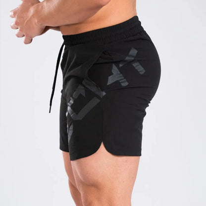 Man wearing black knee-length nylon training shorts with an elastic mid waist.