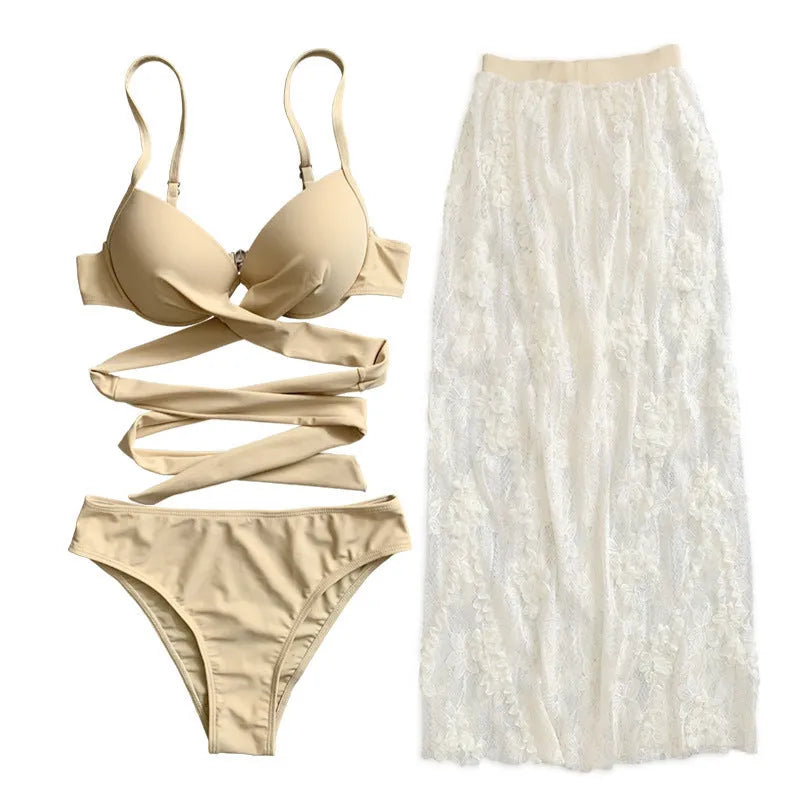 White three-piece backless push-up bikini set with matching skirt on a mannequin.