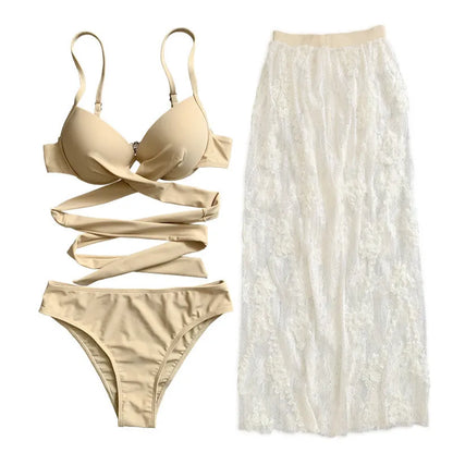White three-piece backless push-up bikini set with matching skirt on a mannequin.