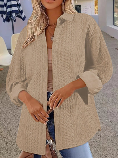 Women's solid colour long-sleeved cardigan sweater in black, shown in a commute-style setting.