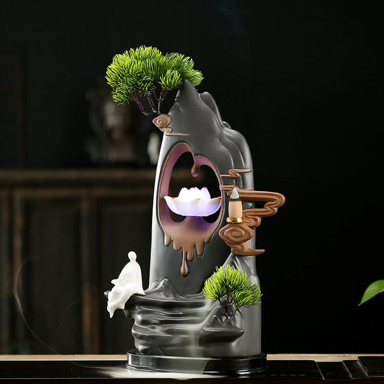 Purple clay tea pet ornament with downward flowing incense smoke and warm LED illumination