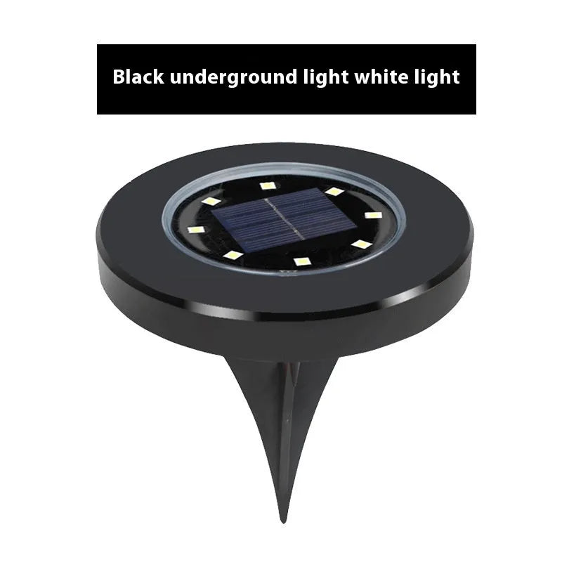 Stainless steel solar garden ground lamp installed in a lawn.