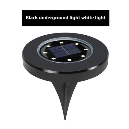 Stainless steel solar garden ground lamp installed in a lawn.
