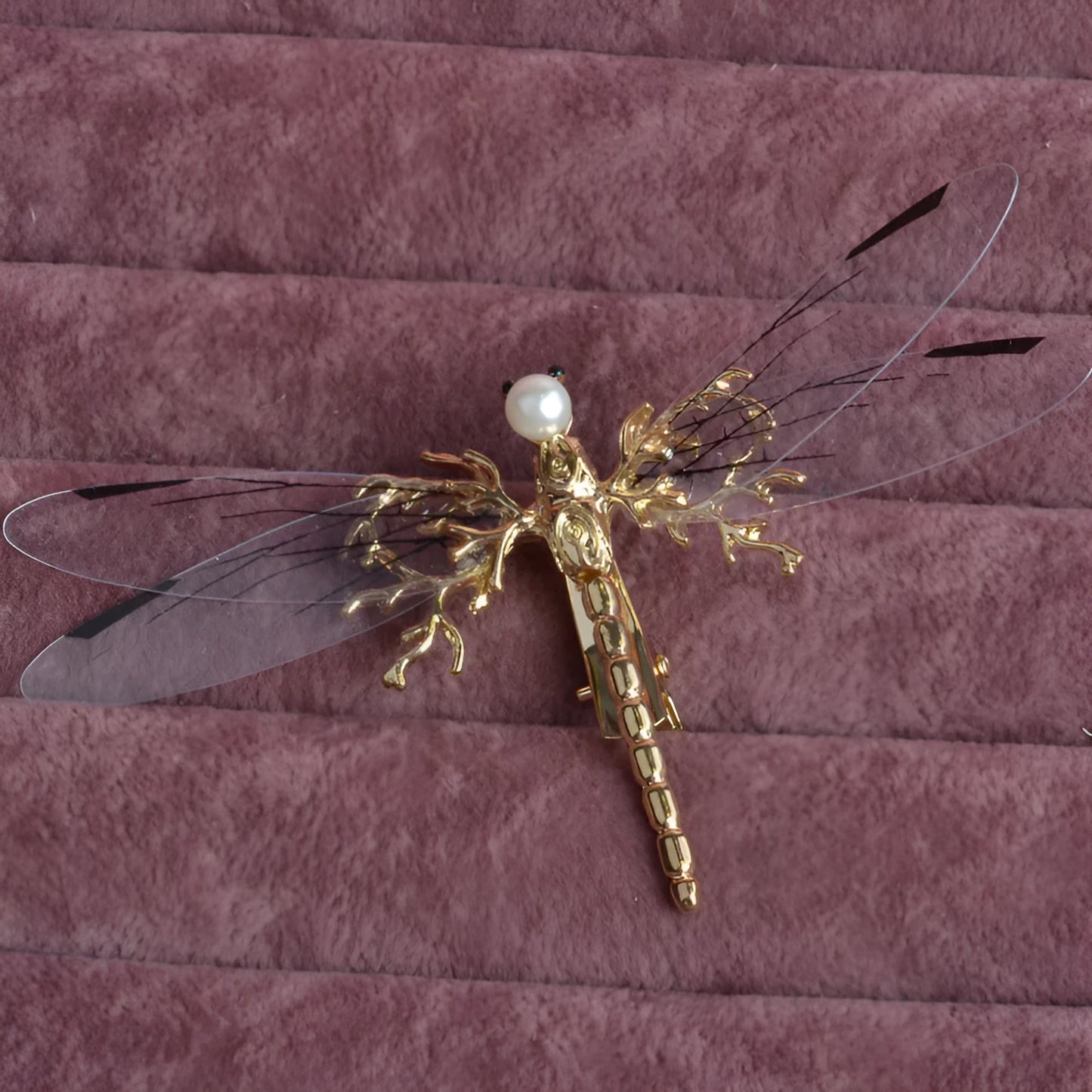 Golden dragonfly-shaped alloy hair clip with electroplated finish and a clip fastening.