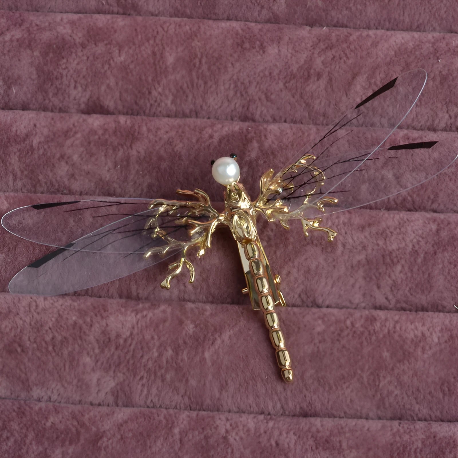 Golden dragonfly-shaped alloy hair clip with electroplated finish and a clip fastening.