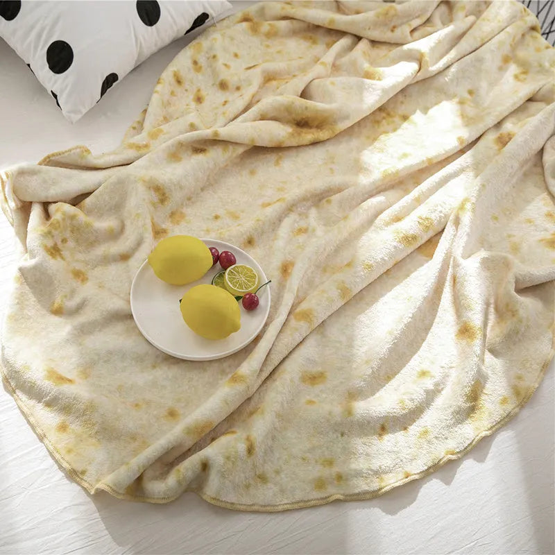 Round flannel burrito blanket with food-themed printing, showing coral fleece texture and wrap-style design