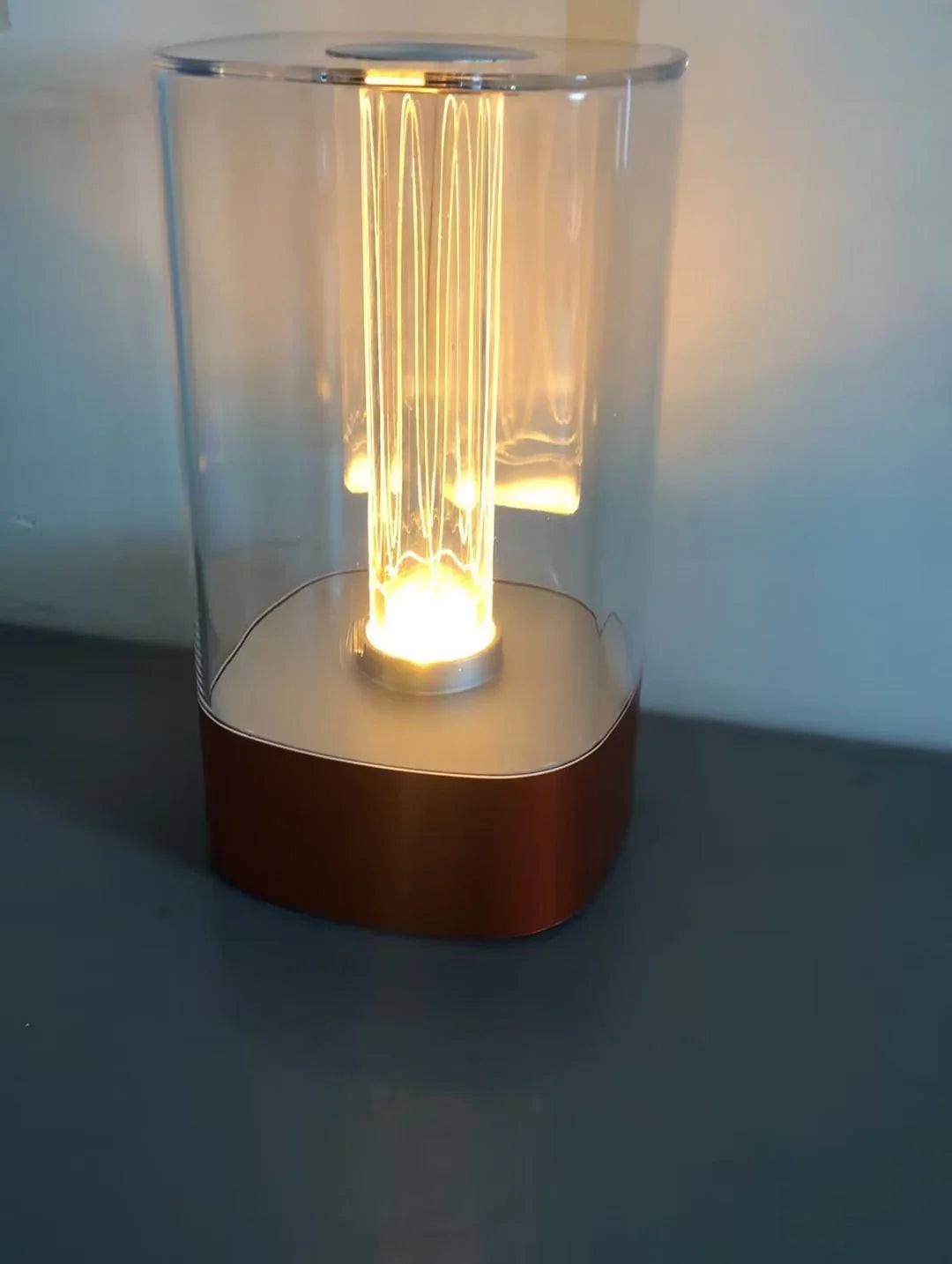 Elegant touch-controlled bedside lamp with soft, warm lighting, unique lamp post design, and wireless USB charging