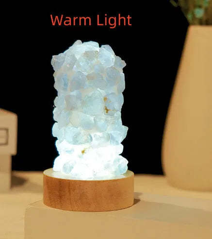 Mini USB night light glowing inside a natural amethyst crystal vug geode on a dark surface.