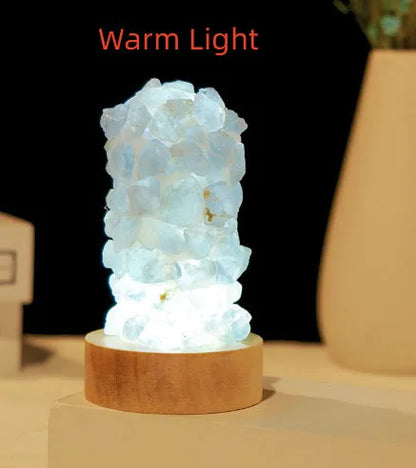 Mini USB night light glowing inside a natural amethyst crystal vug geode on a dark surface.