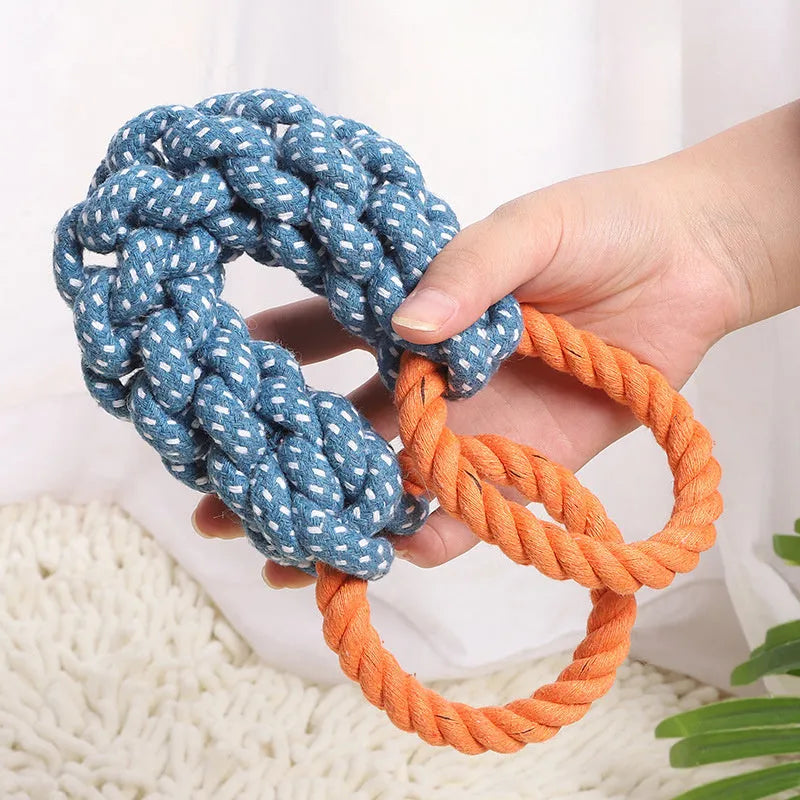 Blue braided bone-shaped cotton rope dog toy with two end rings on a white background.