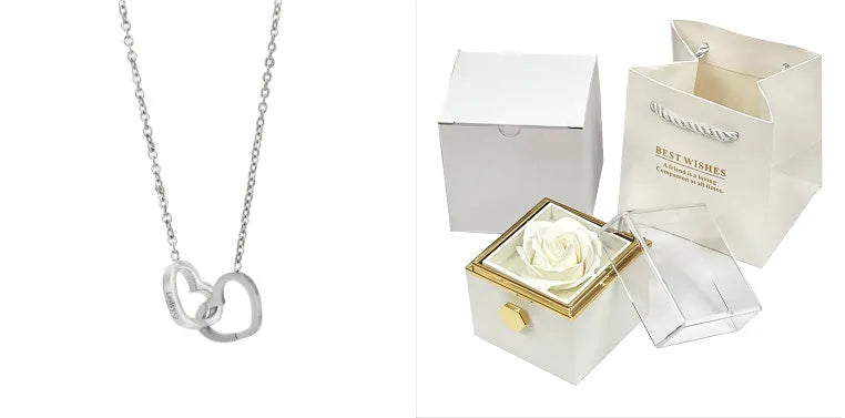 Rotating rose jewellery gift box with a preserved red rose under a clear acrylic dome, showing the interior rotating drawer.