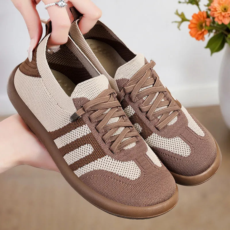 Retro style casual training shoes in flyknit mesh with a soft PU sole and flat heel.