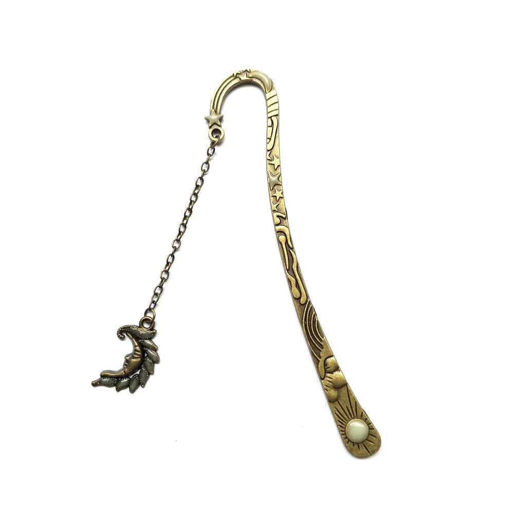 Retro five-pointed star glowing metal bookmark in ancient silver and bronze finishes on an open book.