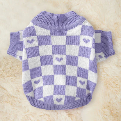 Blue and checkerboard patterned dog coats for small breeds on a white background.