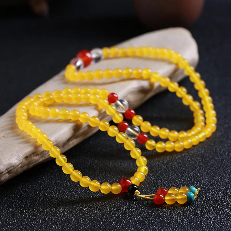 Crystal canary stone 108-bead necklace and bracelet set with geometric beads and lucky cat charm.