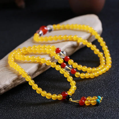Crystal canary stone 108-bead necklace and bracelet set with geometric beads and lucky cat charm.