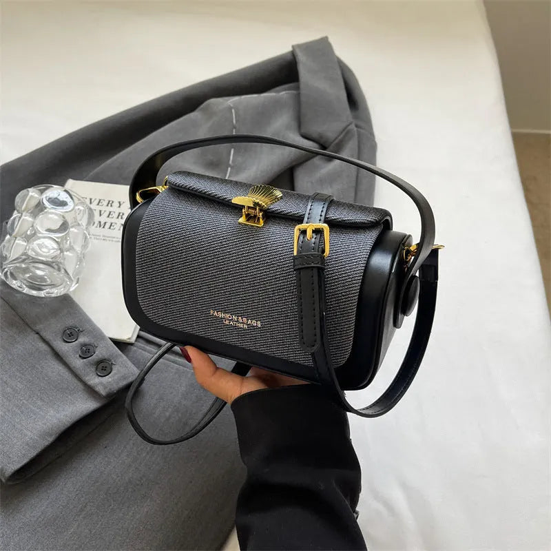 Women's PU leather messenger bag in a horizontal square shape with a lock and adjustable shoulder strap.