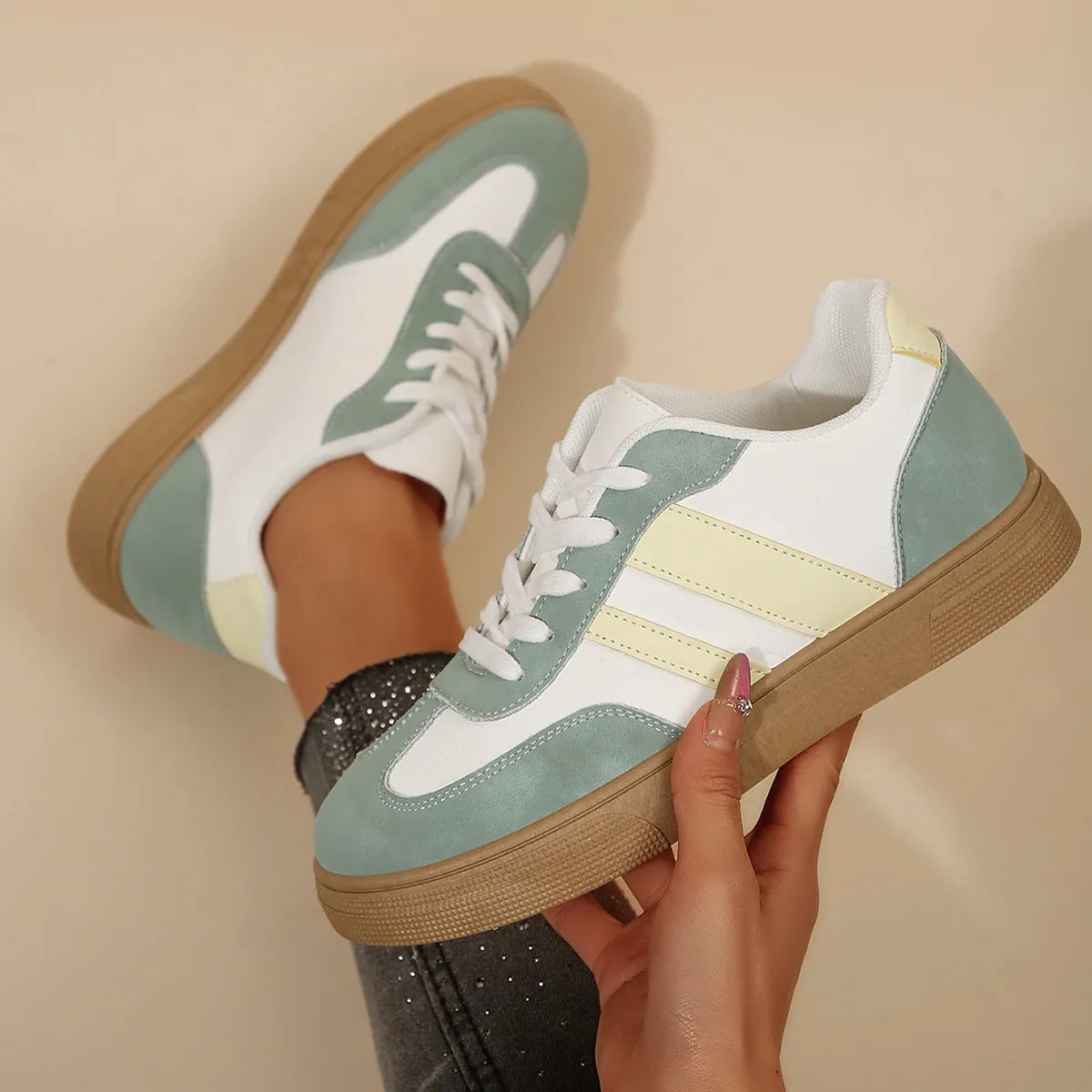 Women's green and white retro-style low-top casual pumps with cross straps and a flat rubber sole.