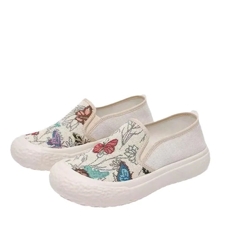 Women's black and white slip-on canvas shoes with round toe and decorative stitching