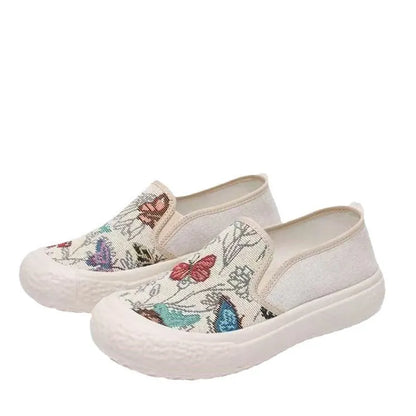 Women's black and white slip-on canvas shoes with round toe and decorative stitching