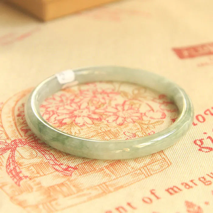 Green jade geometric bracelet with 10mm beads showing traditional Chinese style and adjustable sizing options