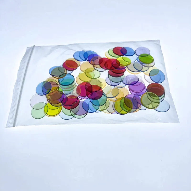 Bag of 100 plastic counting chips in 19mm or 25mm size, solid colour or transparent, for children aged 4 to 6